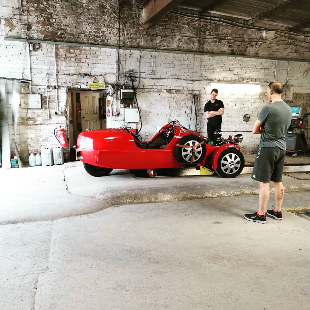 Red three-wheeled vehicle in the garage